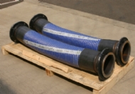 Click to enlarge - Multi plies of heavy duty polypropylene fabric and film are used to create a large bore hose for transfer of hydrocarbons, yet, still very flexible. Stainless steel inner and outer helical wire. 